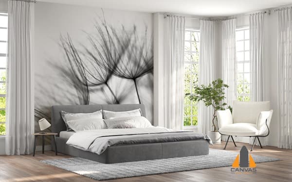 Bedroom with a large dandelion seed head wall mural above the bed, bathed in natural light.