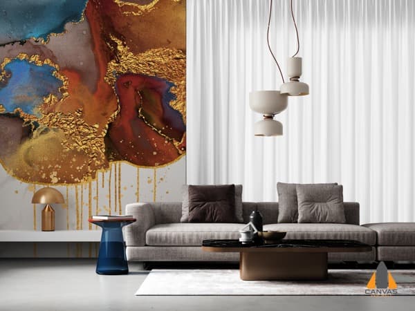 Abstract gold and blue wall mural in a modern living room with a grey sofa and minimalist decor.