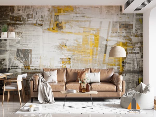 Abstract newspaper wall mural in a modern living room with a brown leather couch.