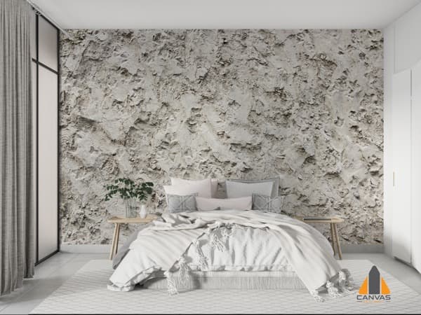 Textured grey wall mural in a modern bedroom with a comfortable bed, demonstrating a wallpaper installation.