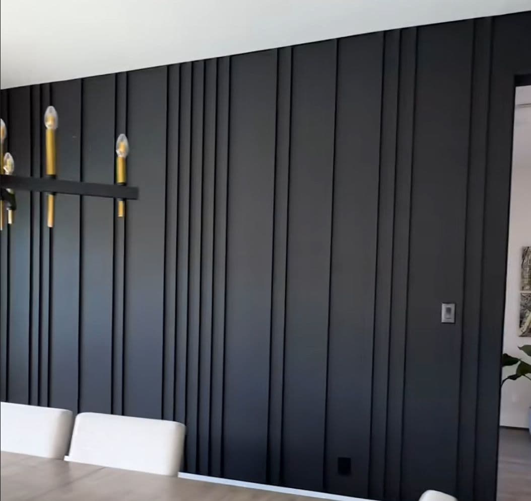 Dark paneled accent wall in a dining room, perfect for custom wallpaper installations in Gauteng.