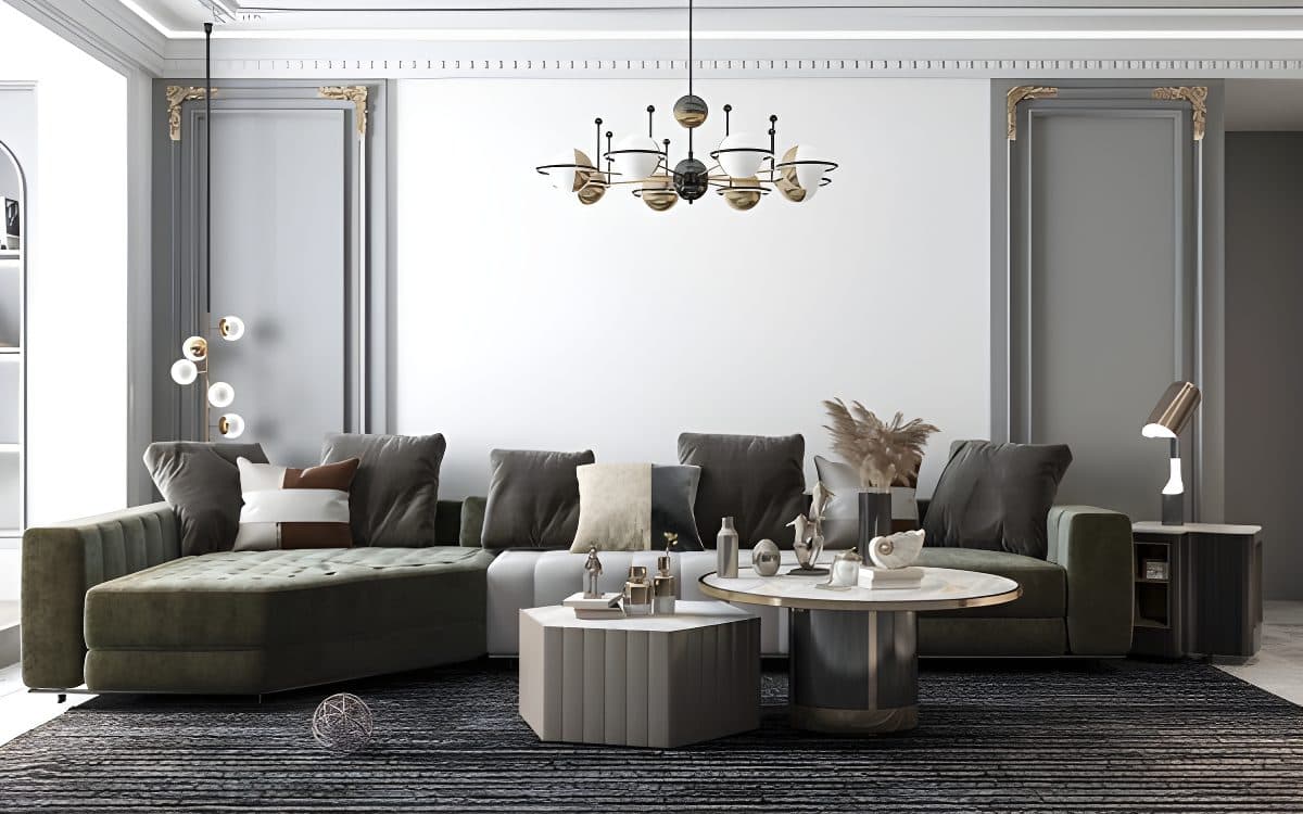 Bright living room with a green velvet sectional sofa, two coffee tables, and a feature white wall for a wallpaper installati