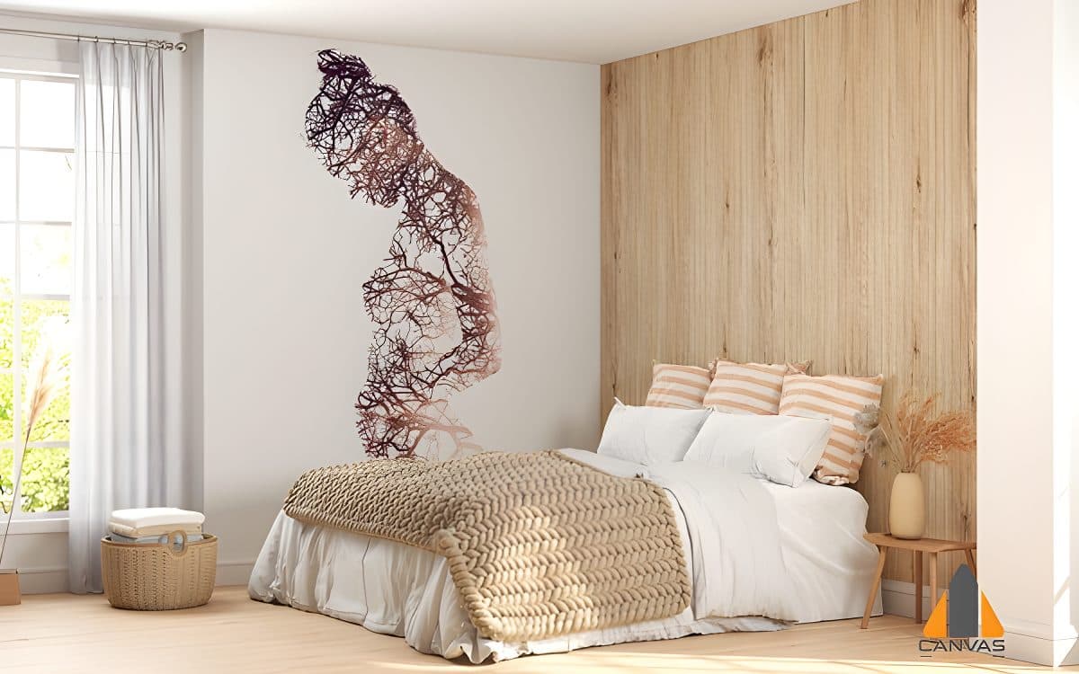 Nature-inspired wall mural of a pregnant woman made of branches in a bedroom.