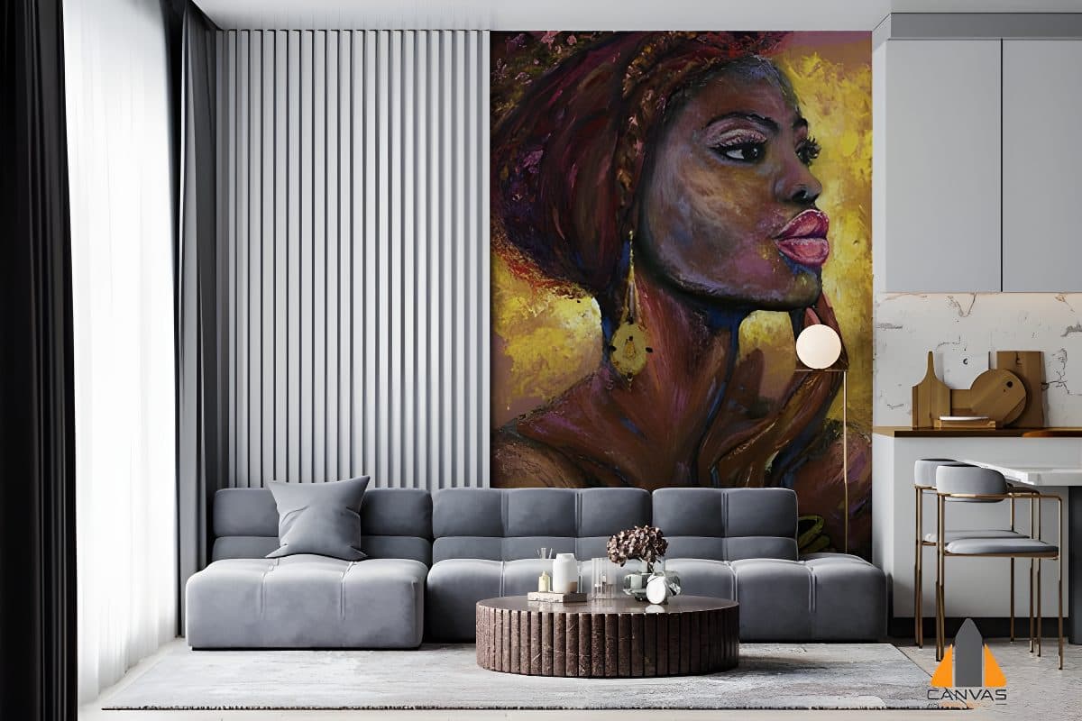 Vibrant portrait of an African woman as a large wall mural in a modern living room with a grey sofa.