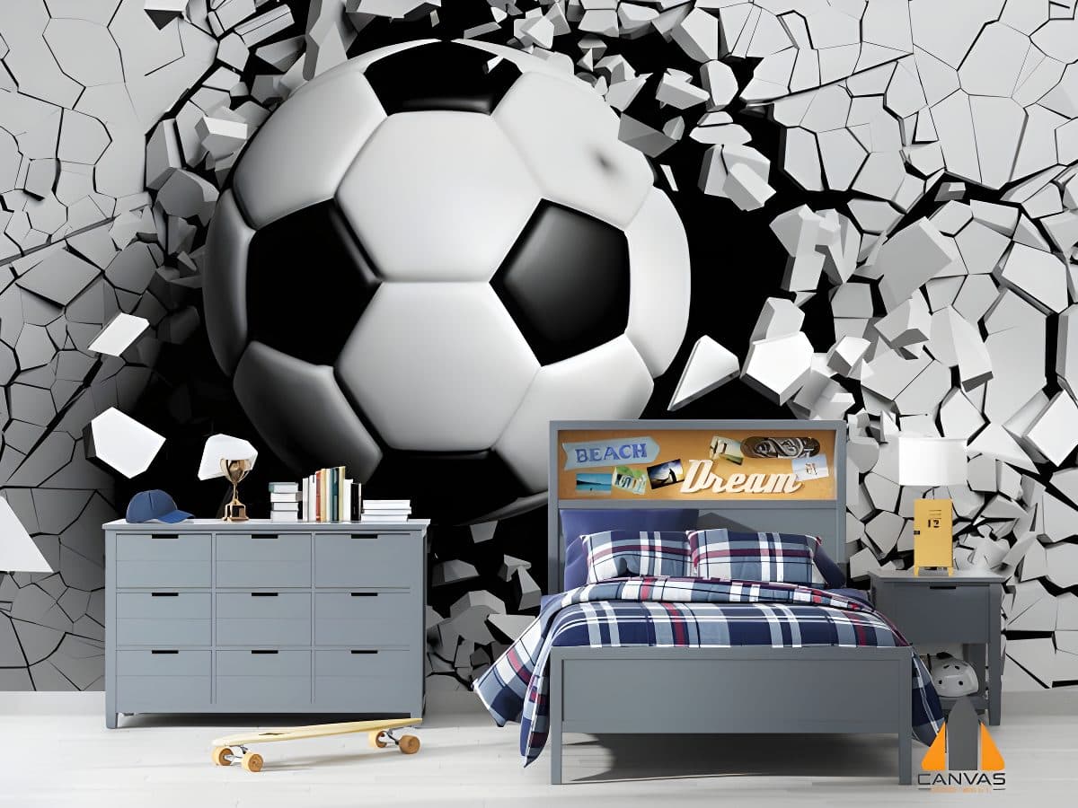 3D soccer ball bursting through a wall mural in a child's bedroom with grey furniture.
