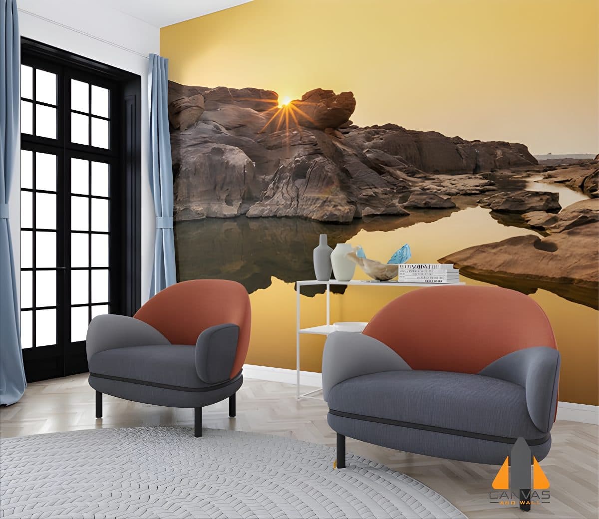 Sunset over a rocky river landscape as a wall mural in a modern living room with two chairs.