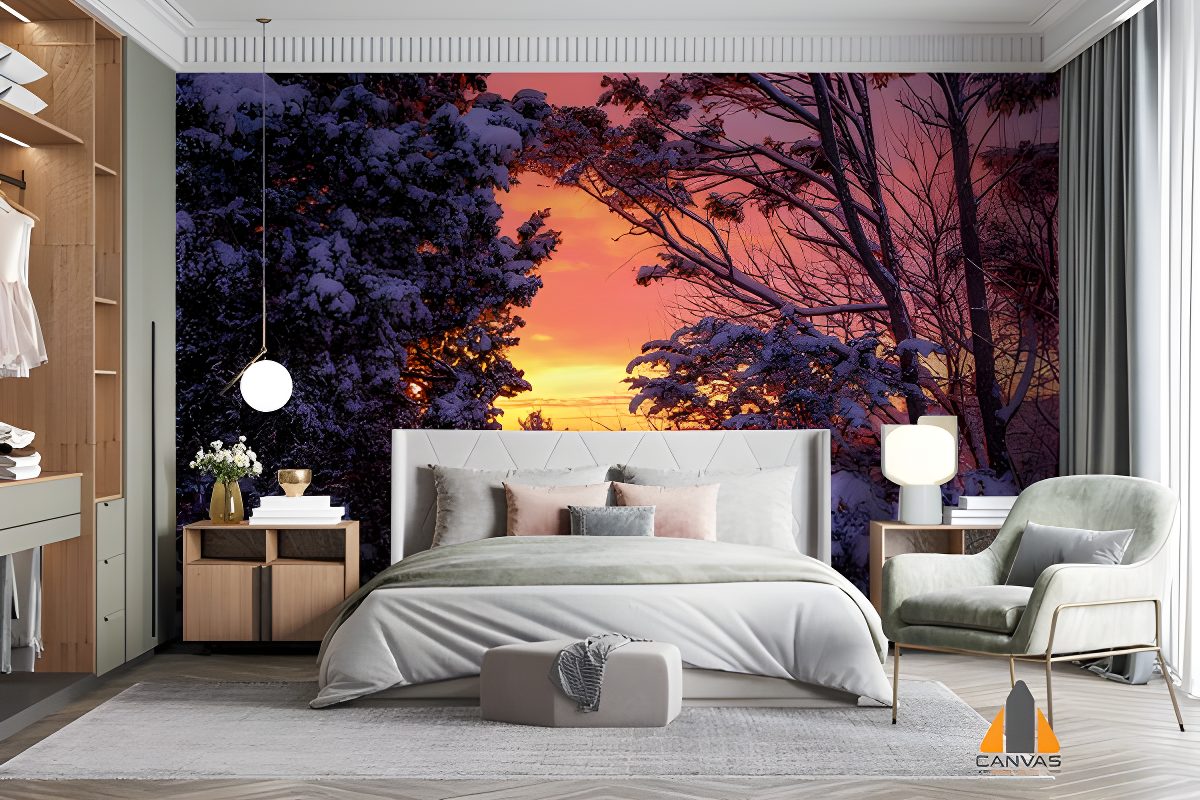 Winter sunset wall mural in a modern bedroom, with snow-covered trees and warm sky hues.