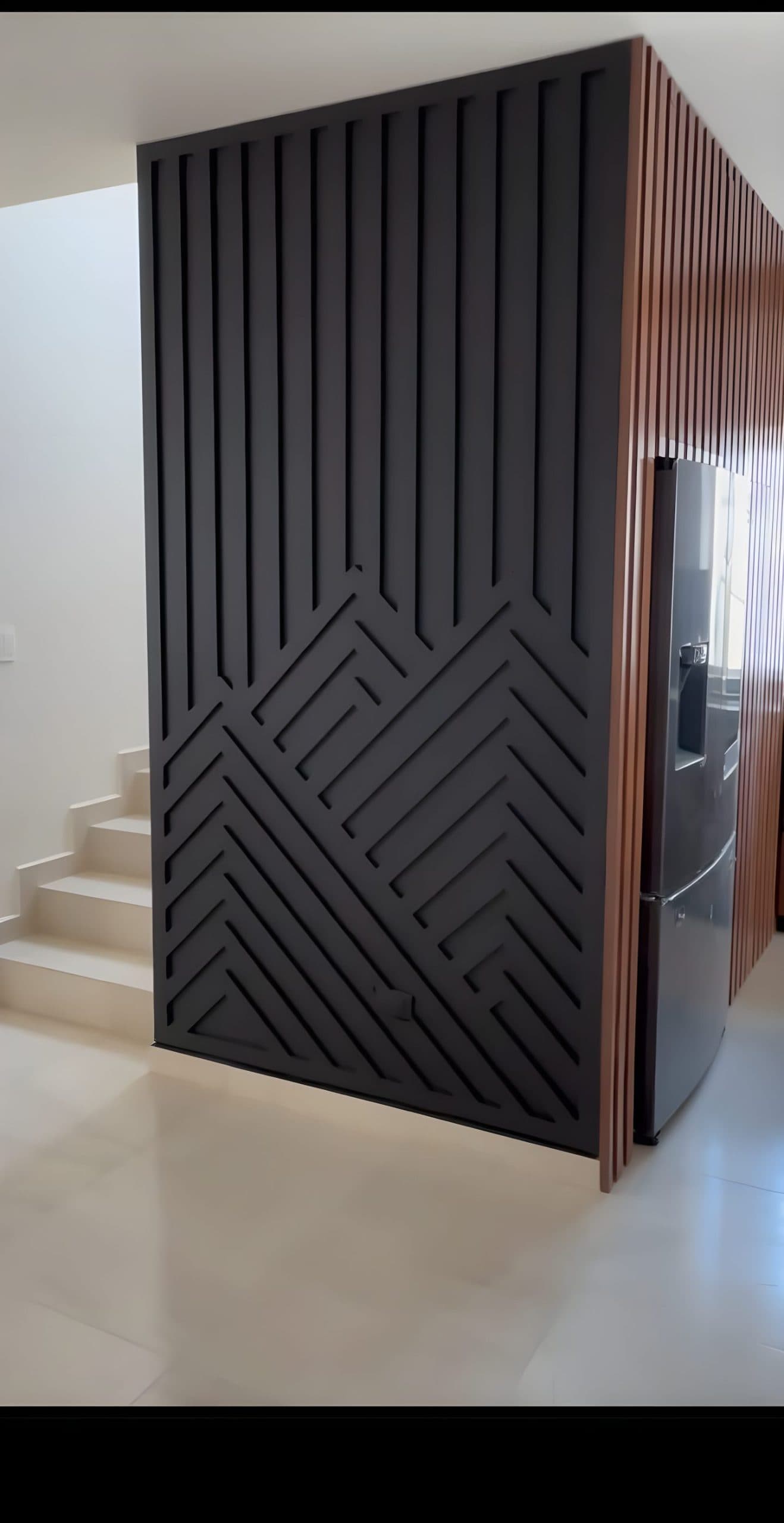 Black slatted accent wall with abstract geometric cutouts and natural wood panels, showcasing custom wallpaper installations.
