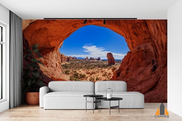 Rock cave desert area wall mural in a modern living room, perfect for wallpaper installations in Gauteng.