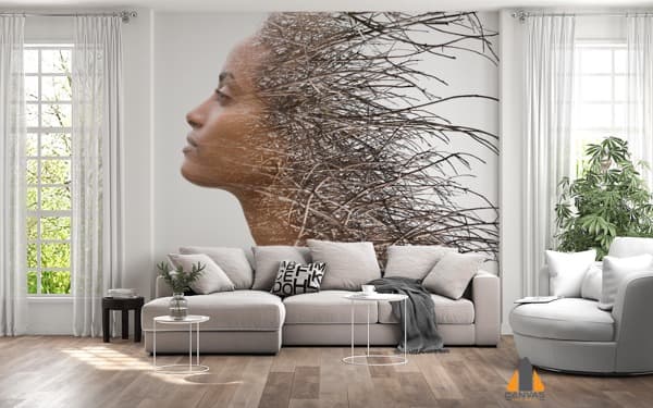 Double exposure of a woman's profile and tree branches, as a wall mural in a modern living room.