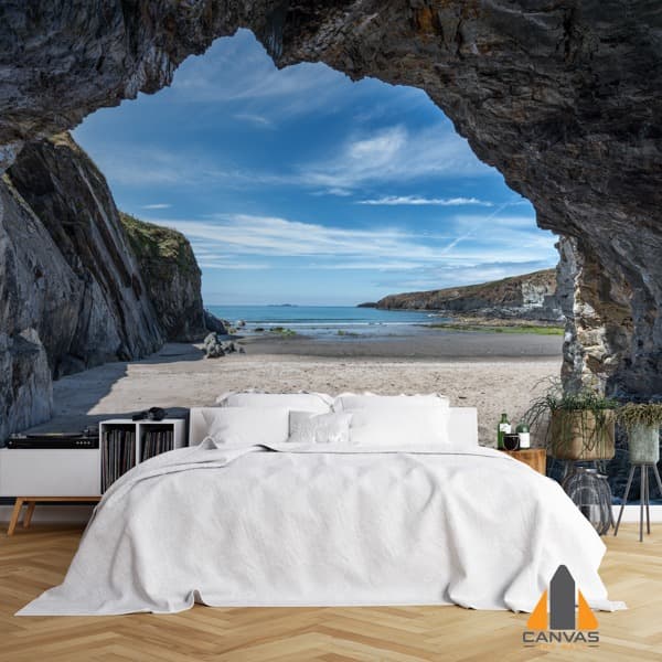 Cave opening to a beach scene wall mural in a modern bedroom, perfect for wallpaper installations Johannesburg.