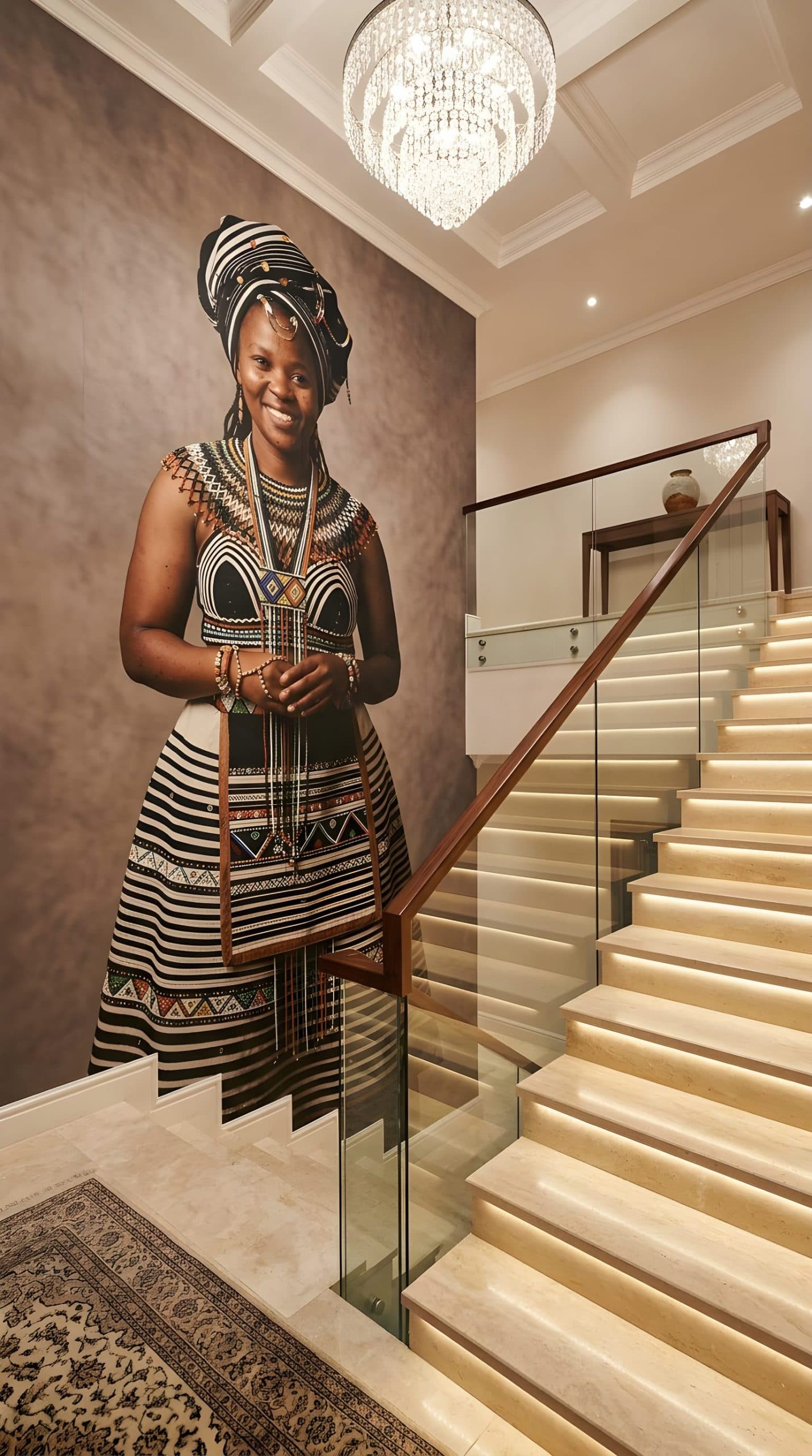 Smiling woman in traditional attire as a wall mural in an elegant hall.