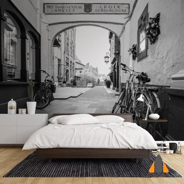 Black and white European street mural with bicycles in a minimalist bedroom. Wallpaper installations in Gauteng.