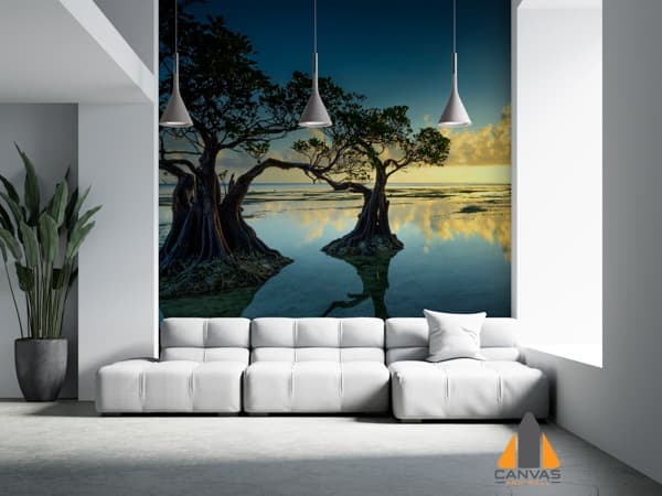 Sunrise over two trees in shallow water, reflecting on the surface, as a wall mural in a modern living room.