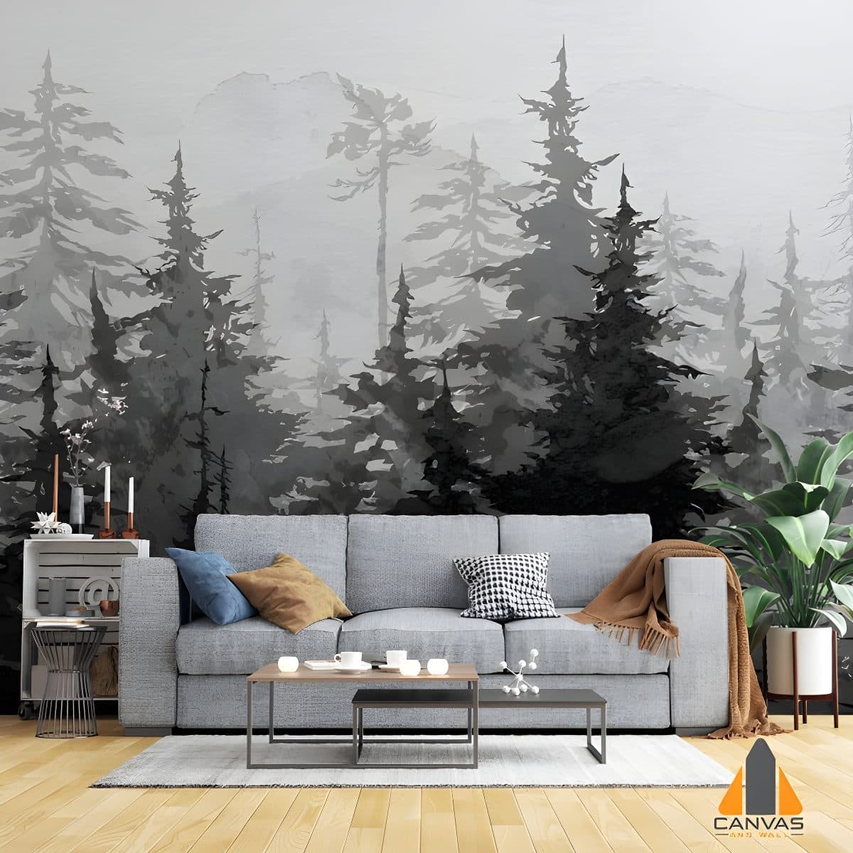 Misty forest wall mural in a modern living room with a grey sofa and potted plant.