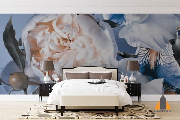 Large floral wall mural featuring white tulips and irises in a bedroom with a cream bed.