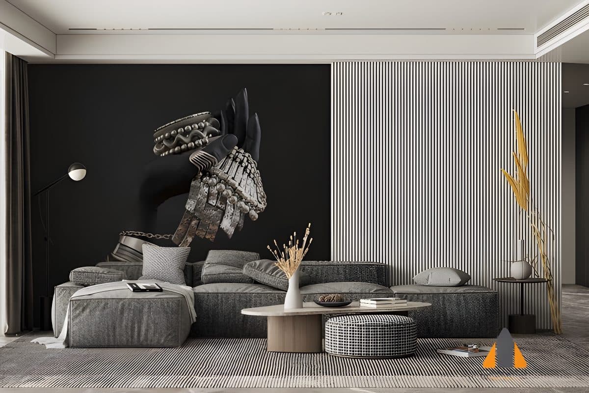 Hand with silver boho jewelry on a dark wallpaper mural in a stylish living room.