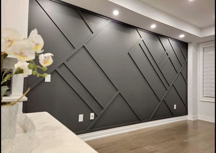 Dark gray accent wall with geometric wood paneling, a stylish custom wallpaper installation.