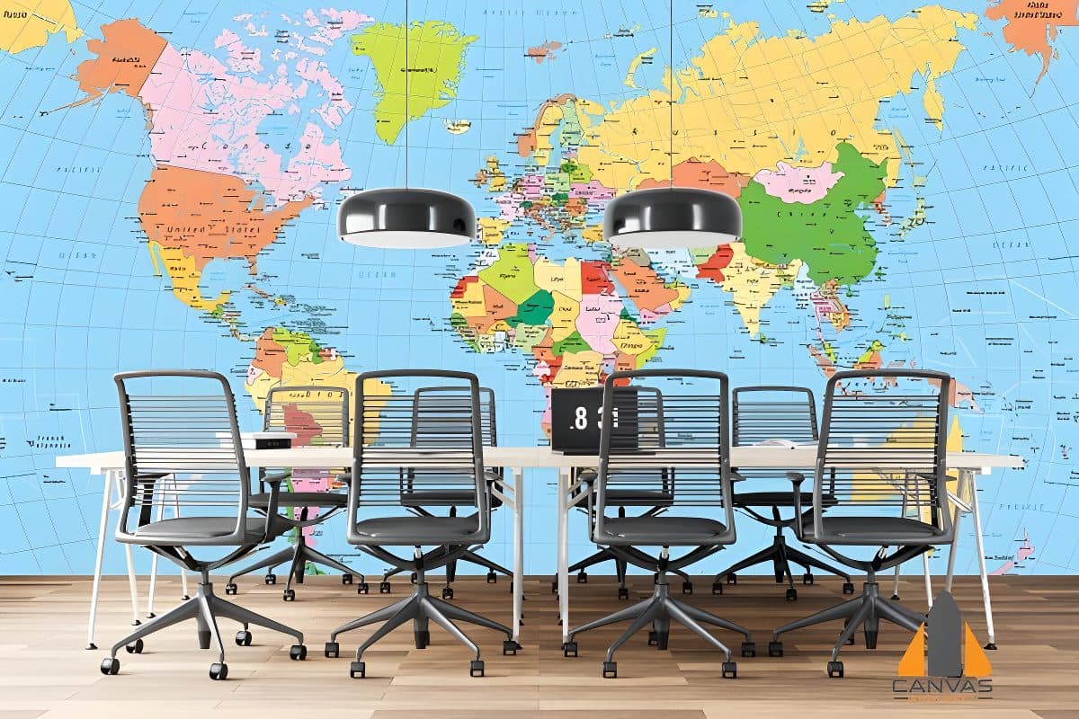 Colorful world map wall mural in a modern office with sleek chairs and a conference table.