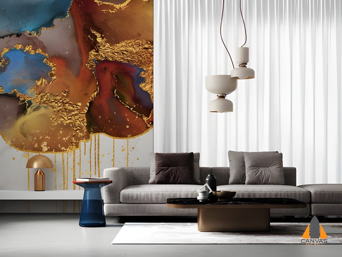 Abstract gold and blue wall mural in a modern living room with a grey sofa and minimalist decor.