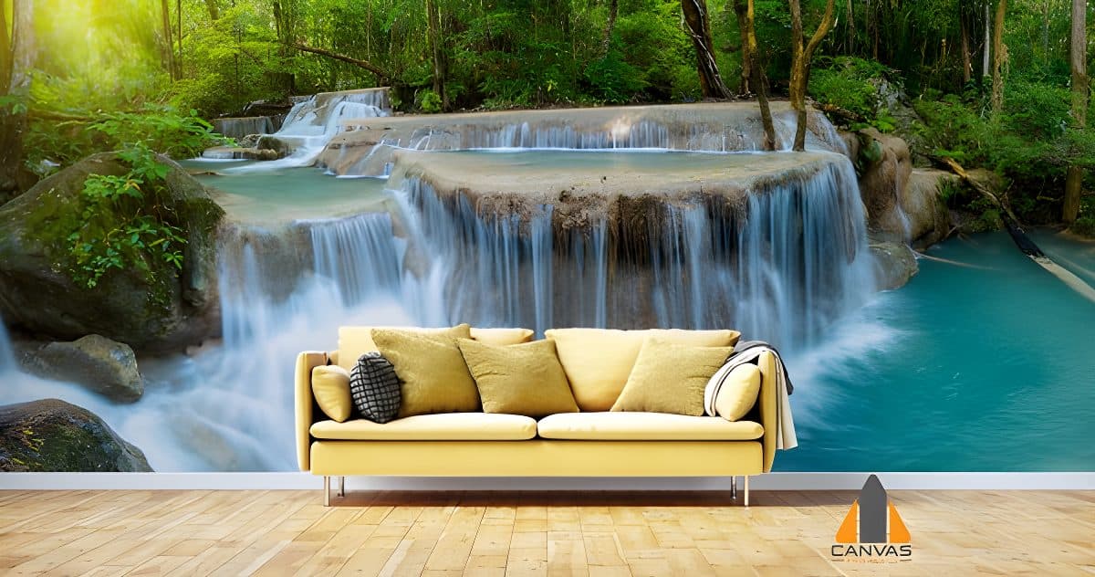 Lush Thai waterfall wall mural in a modern living room with a yellow sofa.