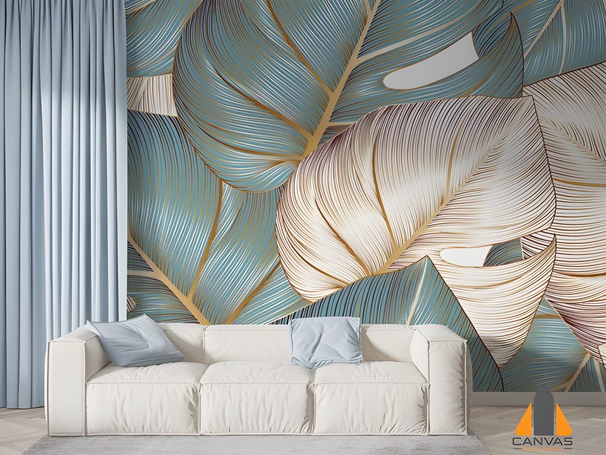 Living room with a large monstera leaf wall mural in teal and gold, installed behind a white sofa.