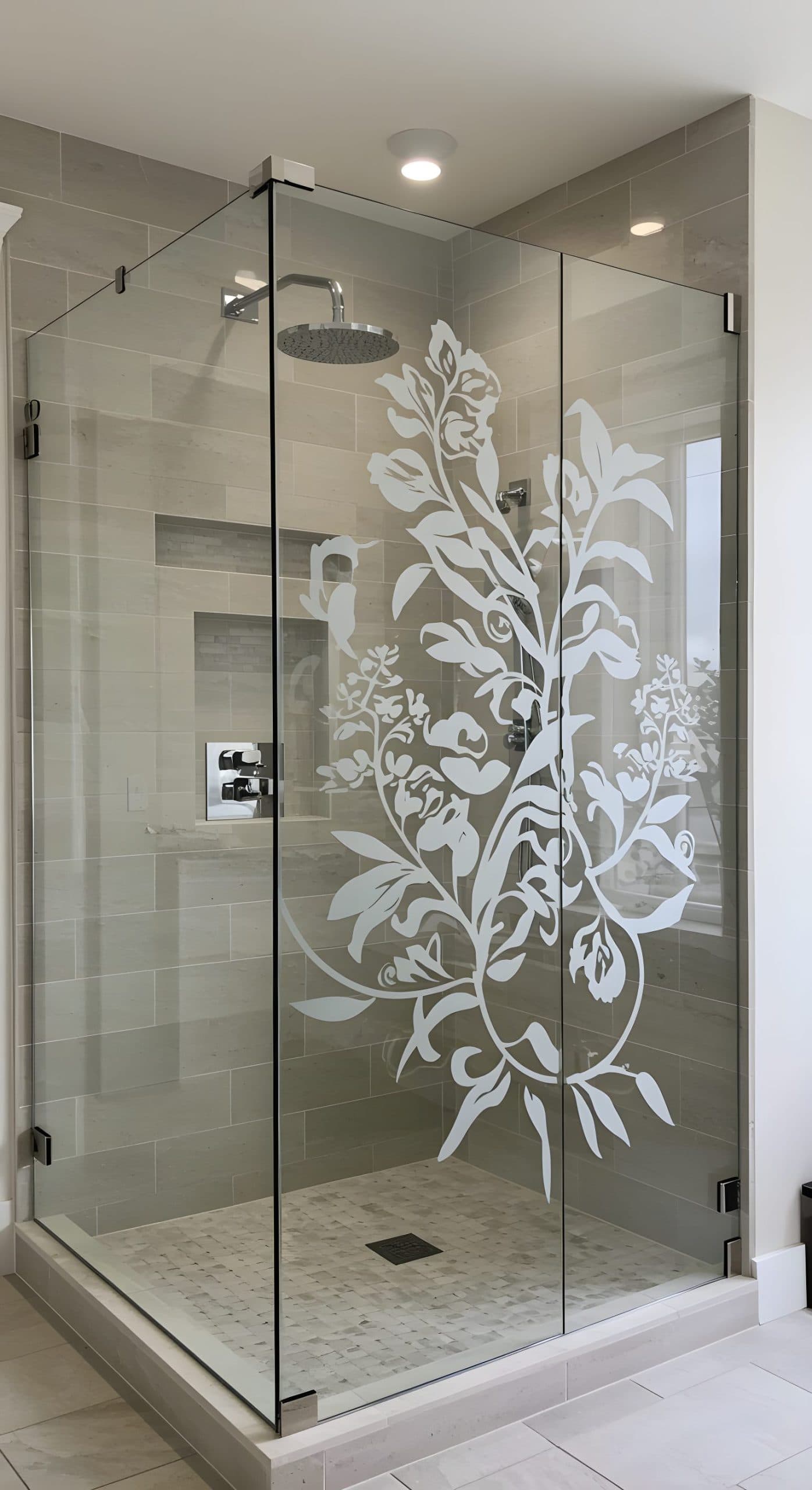 Glass shower cubicle with floral pattern window frosting applied, a stylish custom wallpaper installation.
