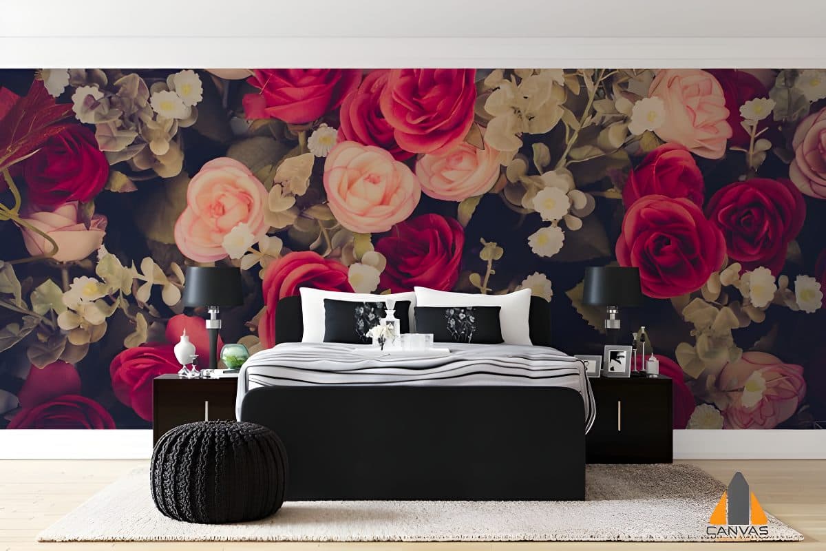 Floral wallpaper in a dark and moody bedroom with a black bed and side tables.