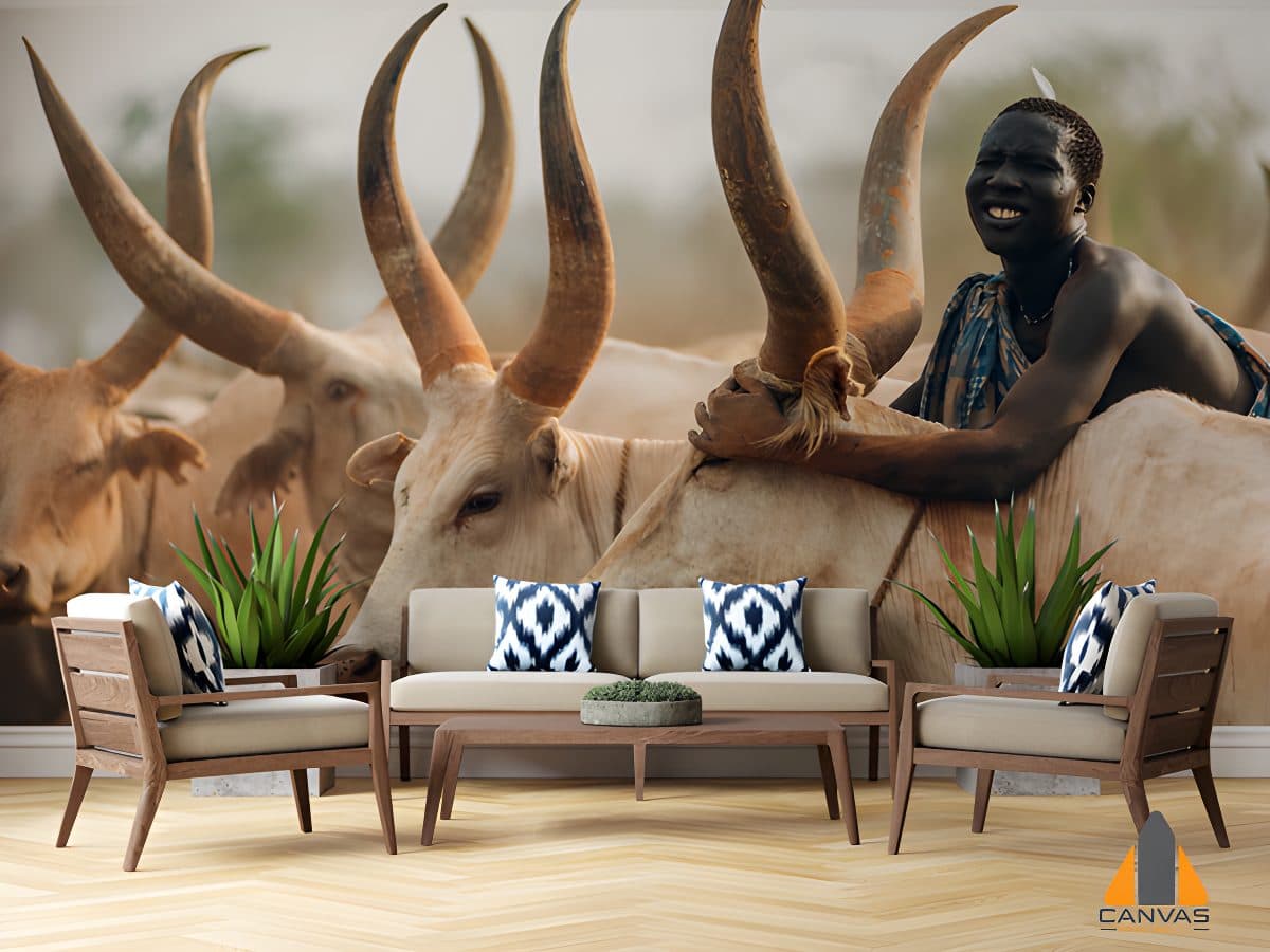 Man from Mundari tribe on back of Ankole cow
