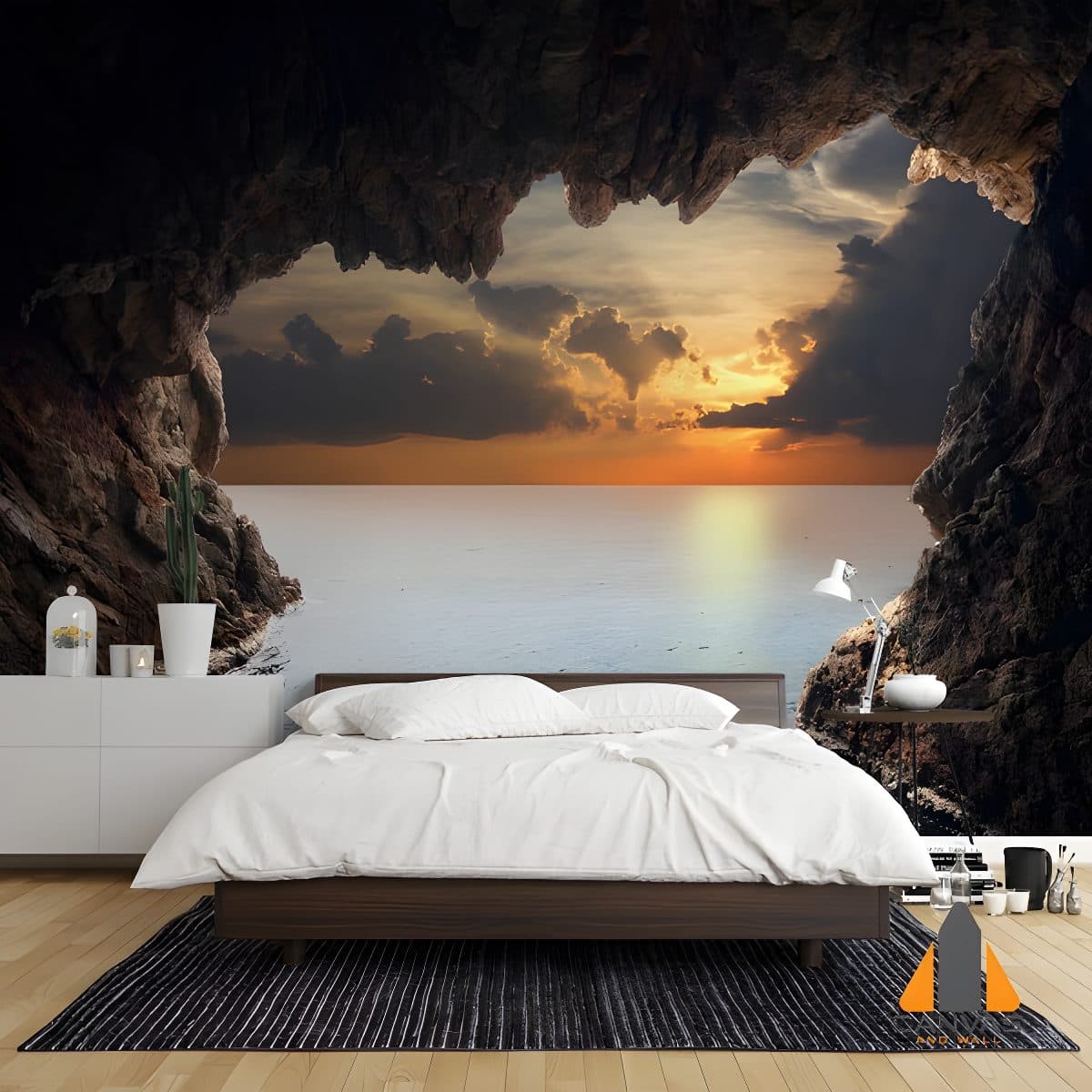 Dramatic sea cave wall mural in a modern bedroom, with a view of the sunset over the ocean.