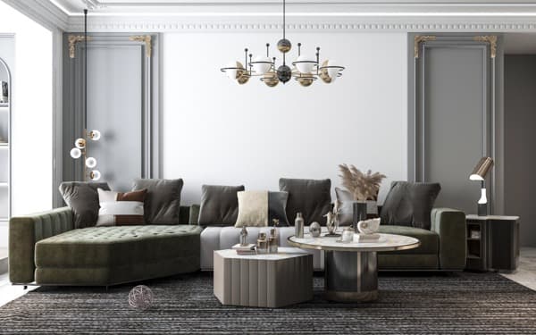 Bright living room with a green velvet sectional sofa, two coffee tables, and a feature white wall for a wallpaper installati