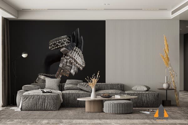 Hand with silver boho jewelry on a dark wallpaper mural in a stylish living room.