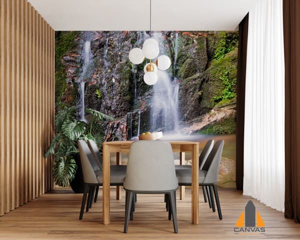 Waterfall wall mural in a modern dining room setting with a wooden table and grey chairs.