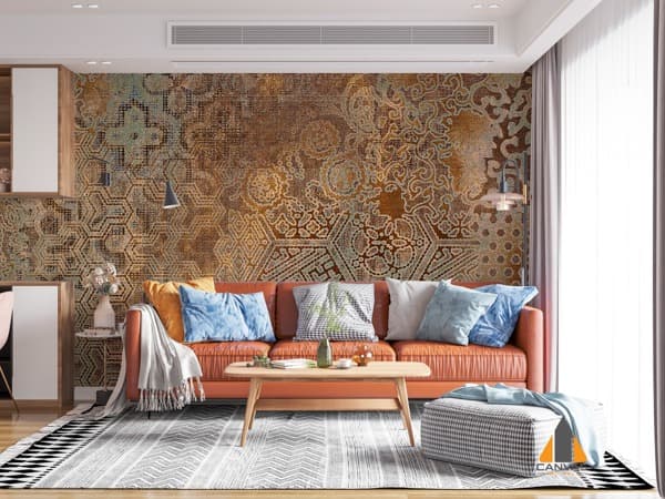Distressed geometric wallpaper visible in a modern living room with an orange sofa.