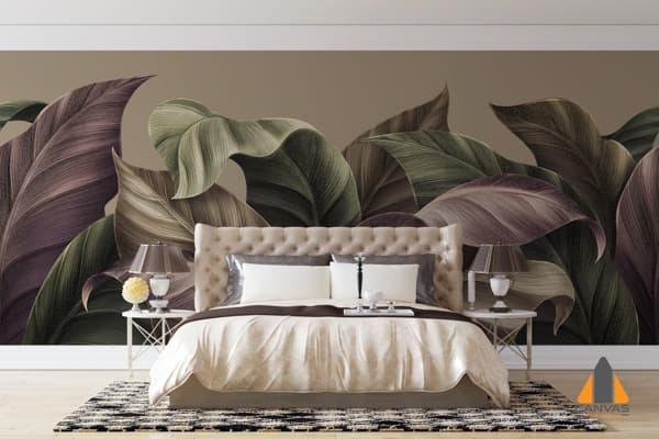 Large tropical leaves wall mural accentuating a stylish bedroom with a tufted headboard furnishing