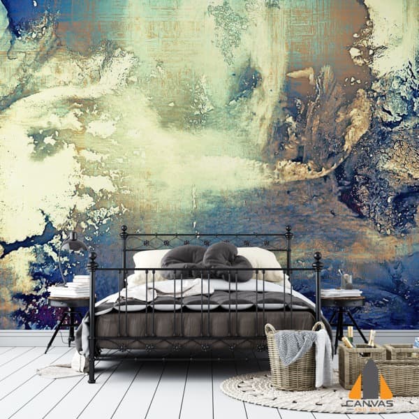 Distressed blue and gold abstract wall mural above a bed, a custom wallpaper installation