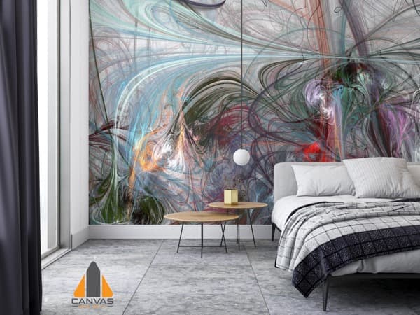 Vibrant abstract wall mural in a modern bedroom with a grey bed and minimalist furniture. Consider wallpaper installations in