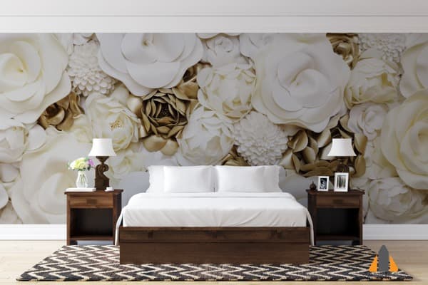 Gold and white floral wall mural in an elegant bedroom with a wooden bed and bedside tables.