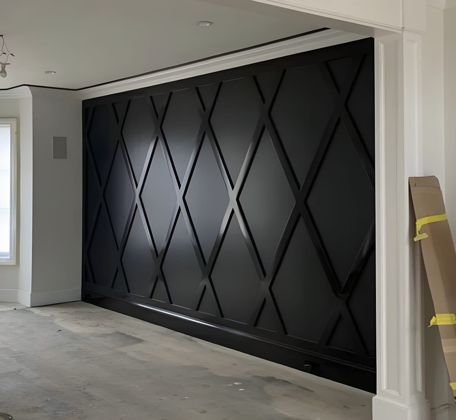 Black accent wall with a geometric diamond pattern in a room under construction, ideal for wallpaper installations in Gauteng