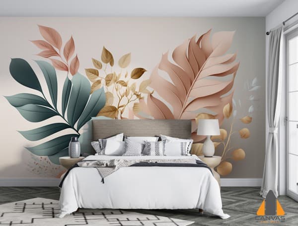 Pastel green and pink tropical leaves wall mural behind a bed in a light bedroom.