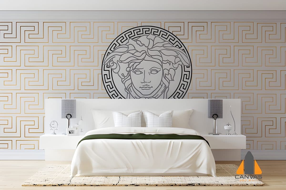 Versace Medusa head custom wall mural above a white bed, with golden geometric wallpaper in a stylish bedroom.