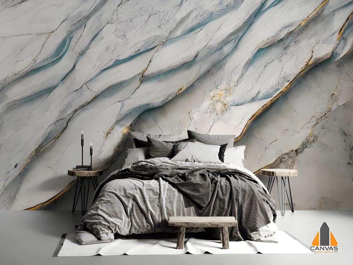 A bedroom with a bed and concrete floor, featuring a dramatic marble-effect wall mural with gold and blue veins.