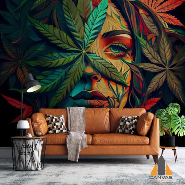 Vibrant woman's face with marijuana leaves as a wall mural in a modern living room setting.