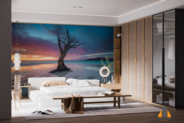 Dead tree in water at sunset