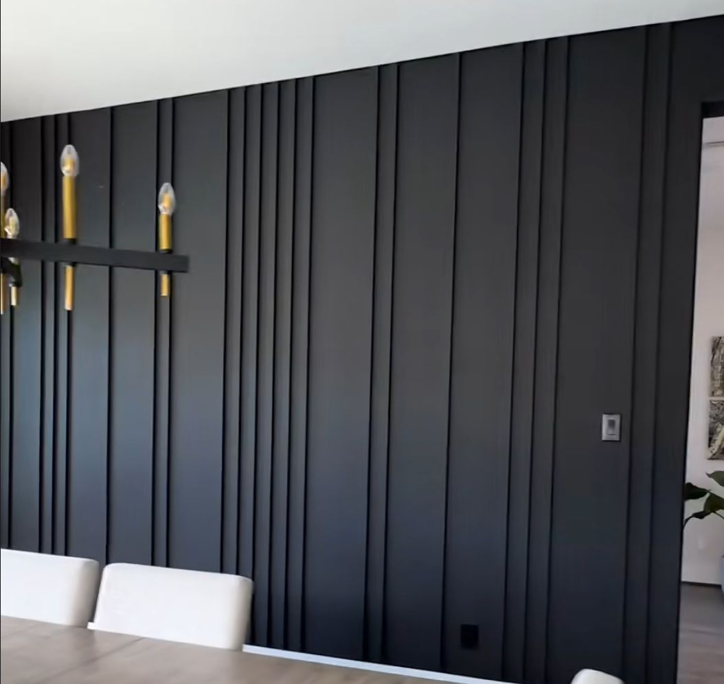 Dark paneled accent wall in a dining room, perfect for custom wallpaper installations in Gauteng.